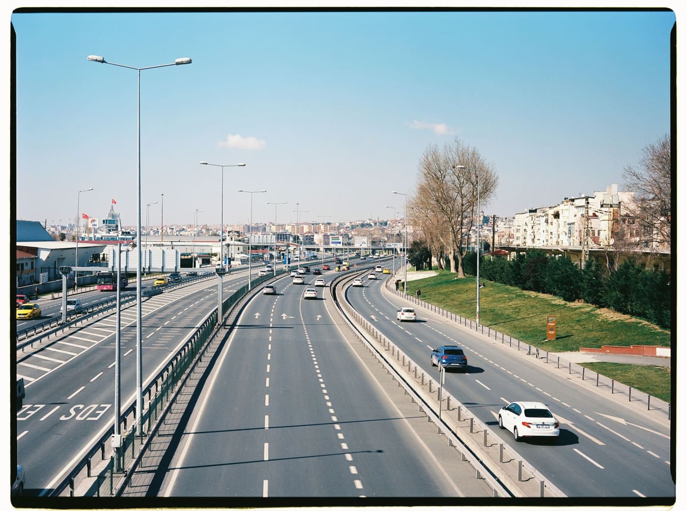 Aerial view of an expressway with traffic and a city in the distance