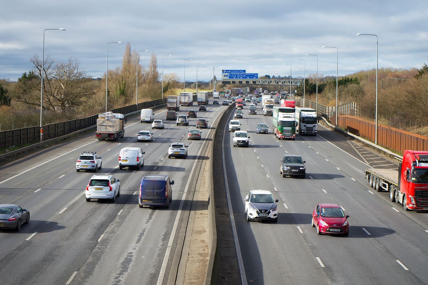 Cars and trucks travelling on a busy multi-lane highway in daylight
