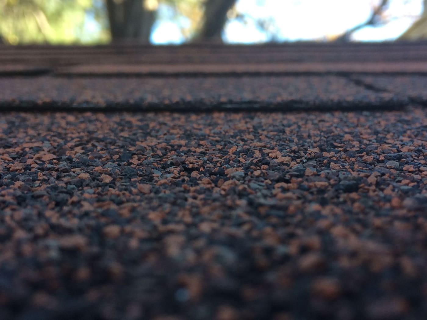 Close-up of dark textured asphalt roof shingles